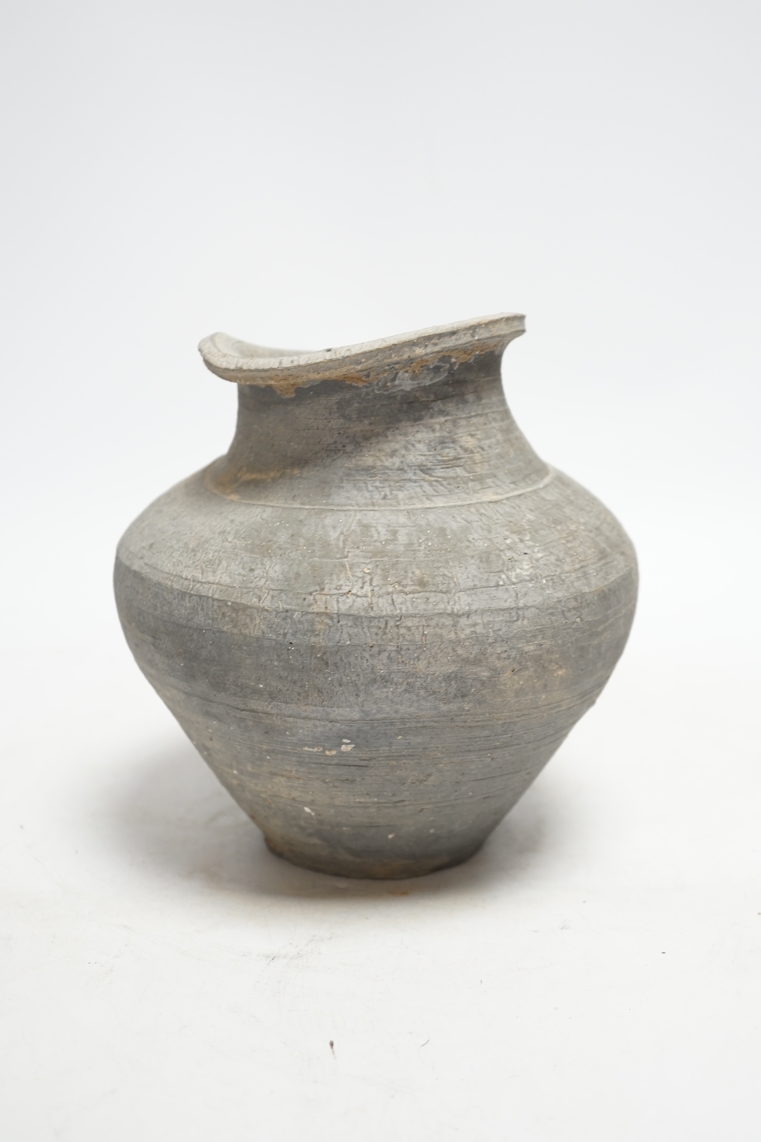 A Chinese grey pottery ribbed jar, probably Han dynasty, 19cm high